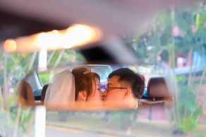 Groom and bride sharing a passionate kiss